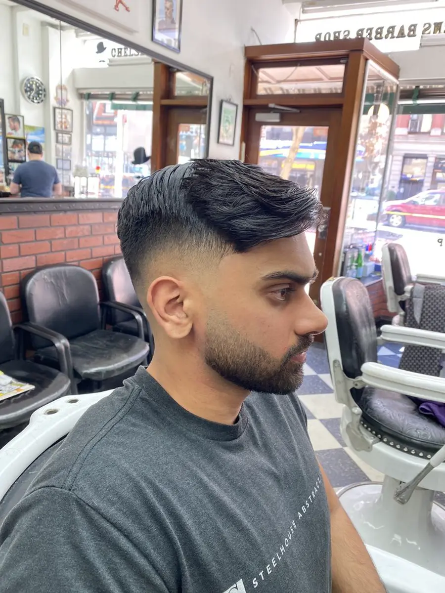 Classic side-part pompadour cut at a Chelsea barbershop